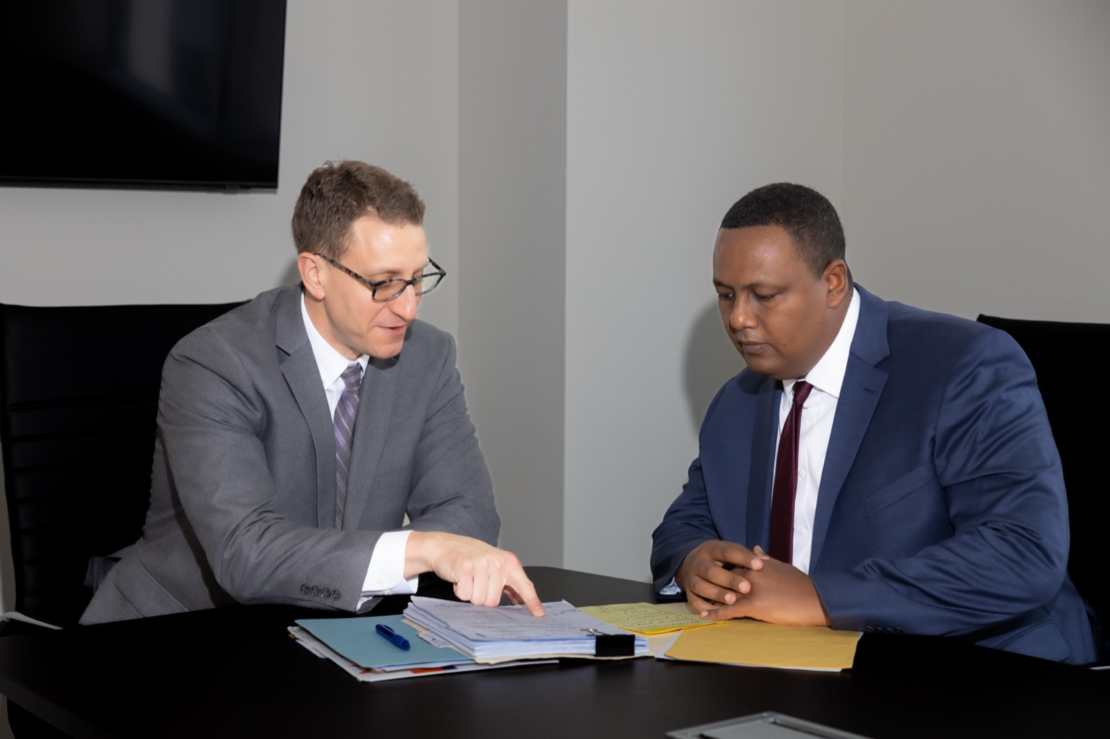 Chad Mason and Kahn Kassegn reviewing a case file